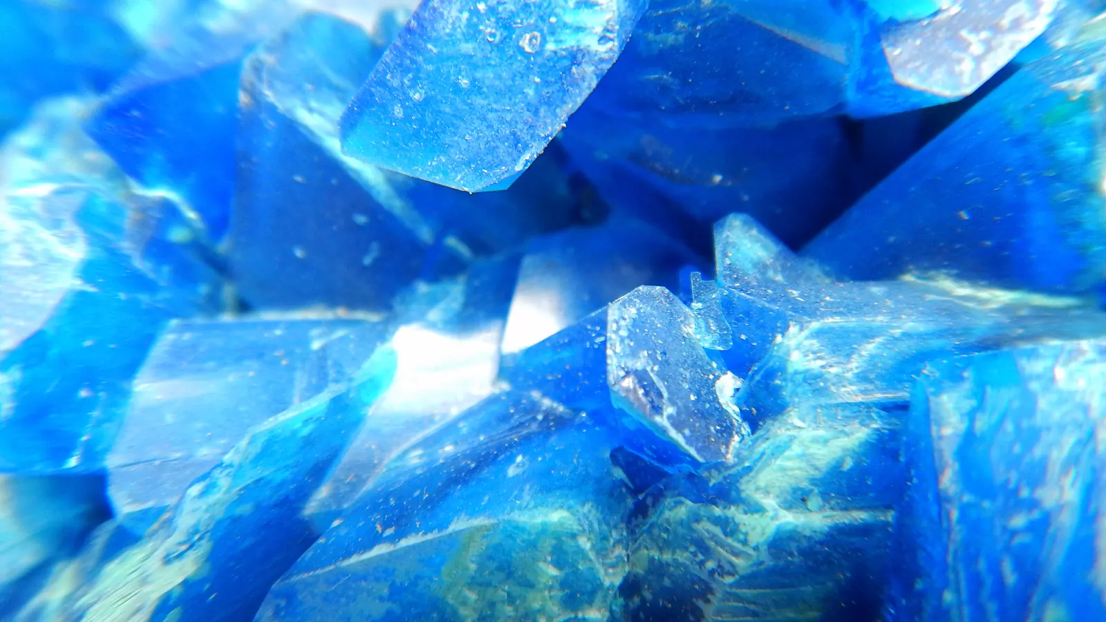 Close-up of deep blue copper(II) sulfate crystals, the copper chemistry behind the GHK-Cu peptide complex