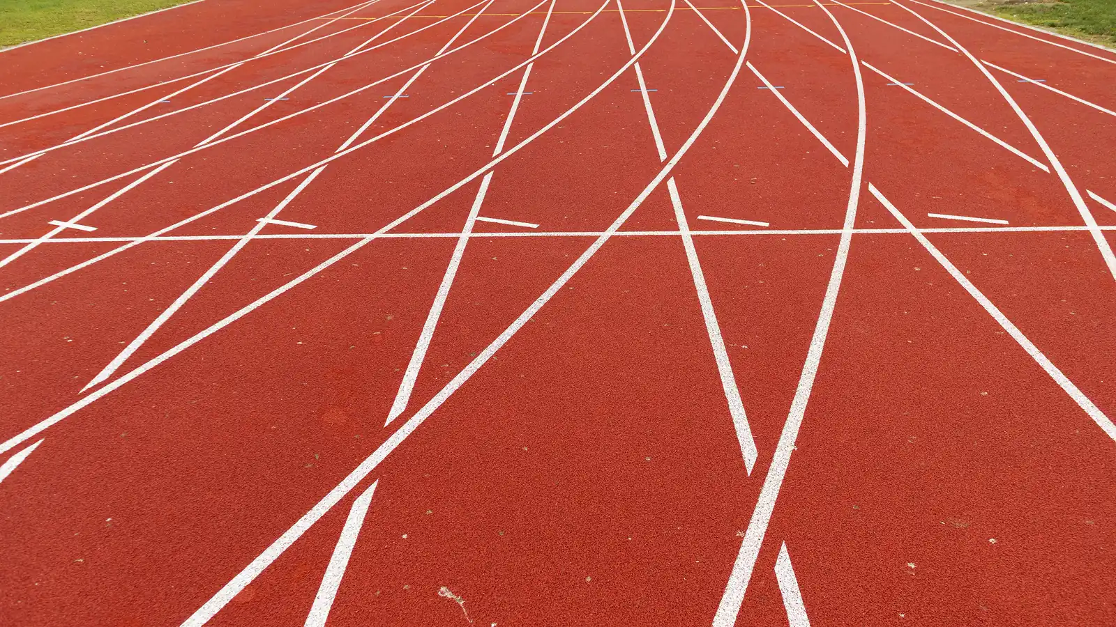 Empty curved lanes of a red athletics track, the setting for sport governed by the WADA Prohibited List